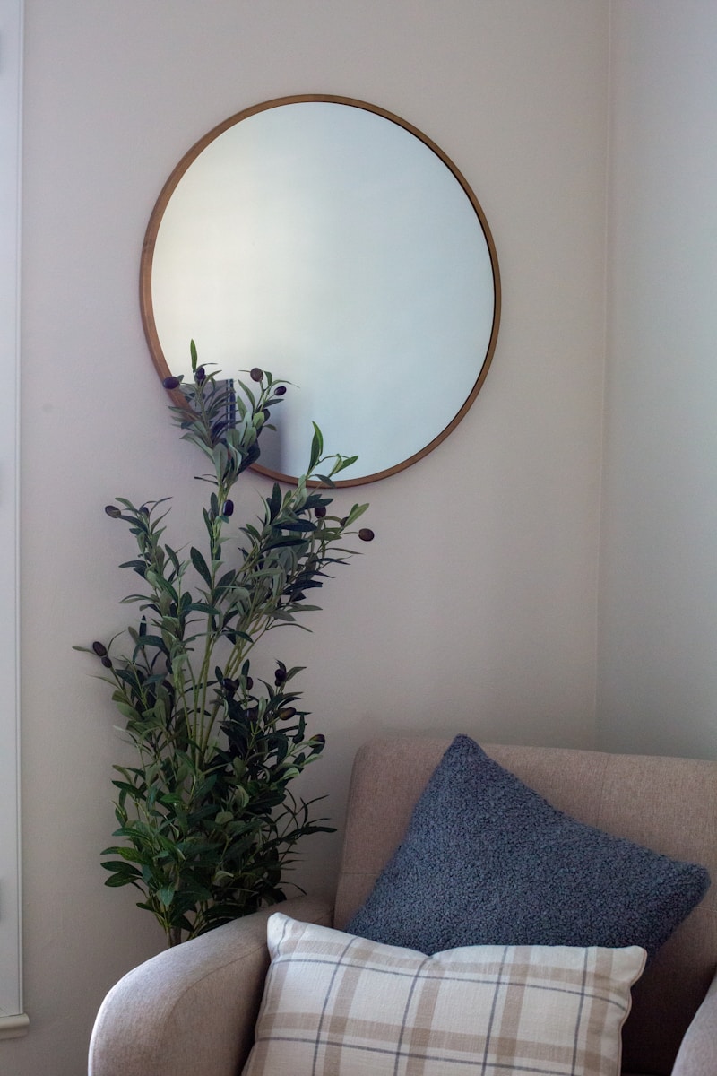 A living room with a couch and a mirror on the wall